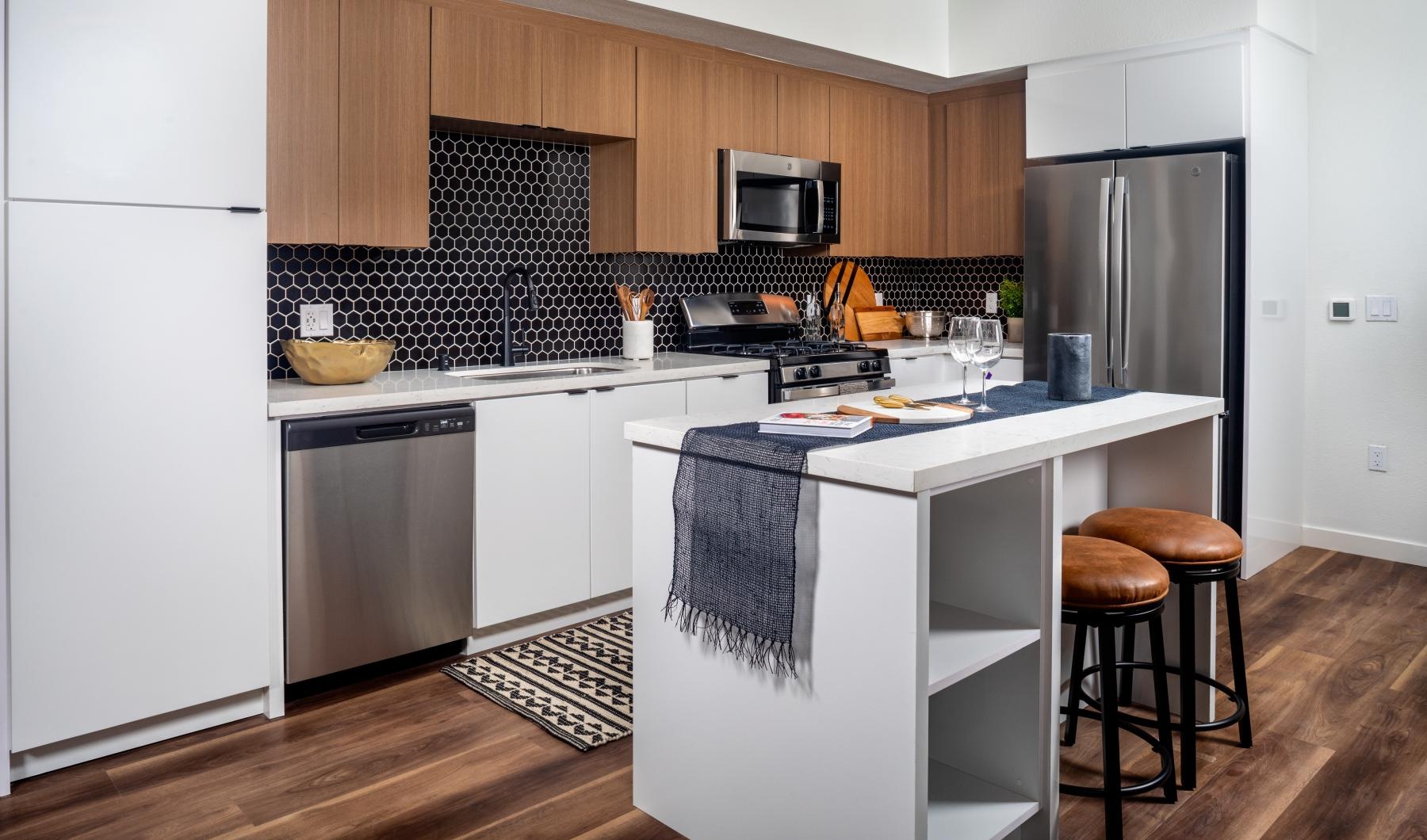 Beautiful kitchens with designer finishes a kitchen with a bar stool and a table